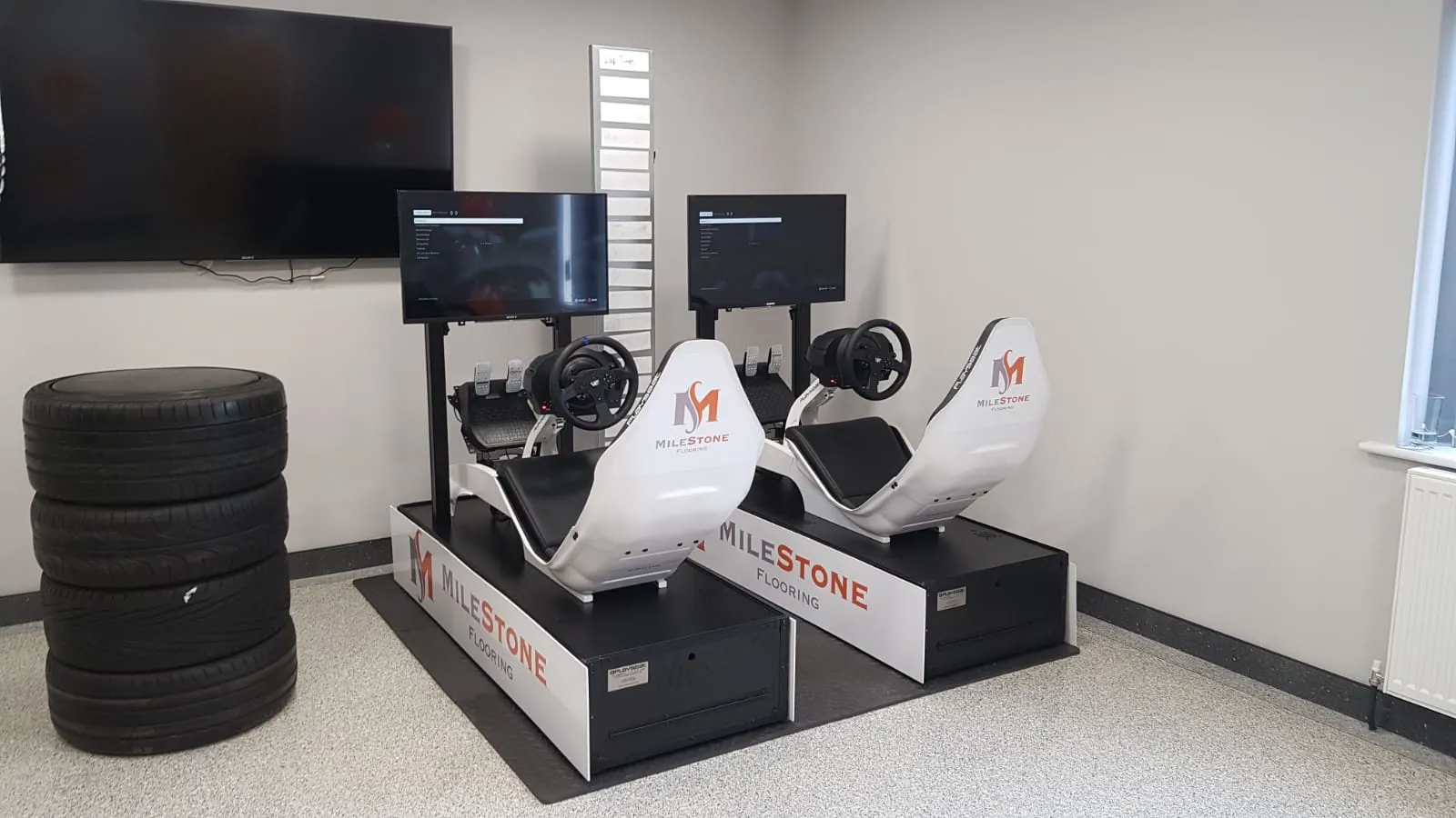 Racing simulator with branded seat back and branded base panels