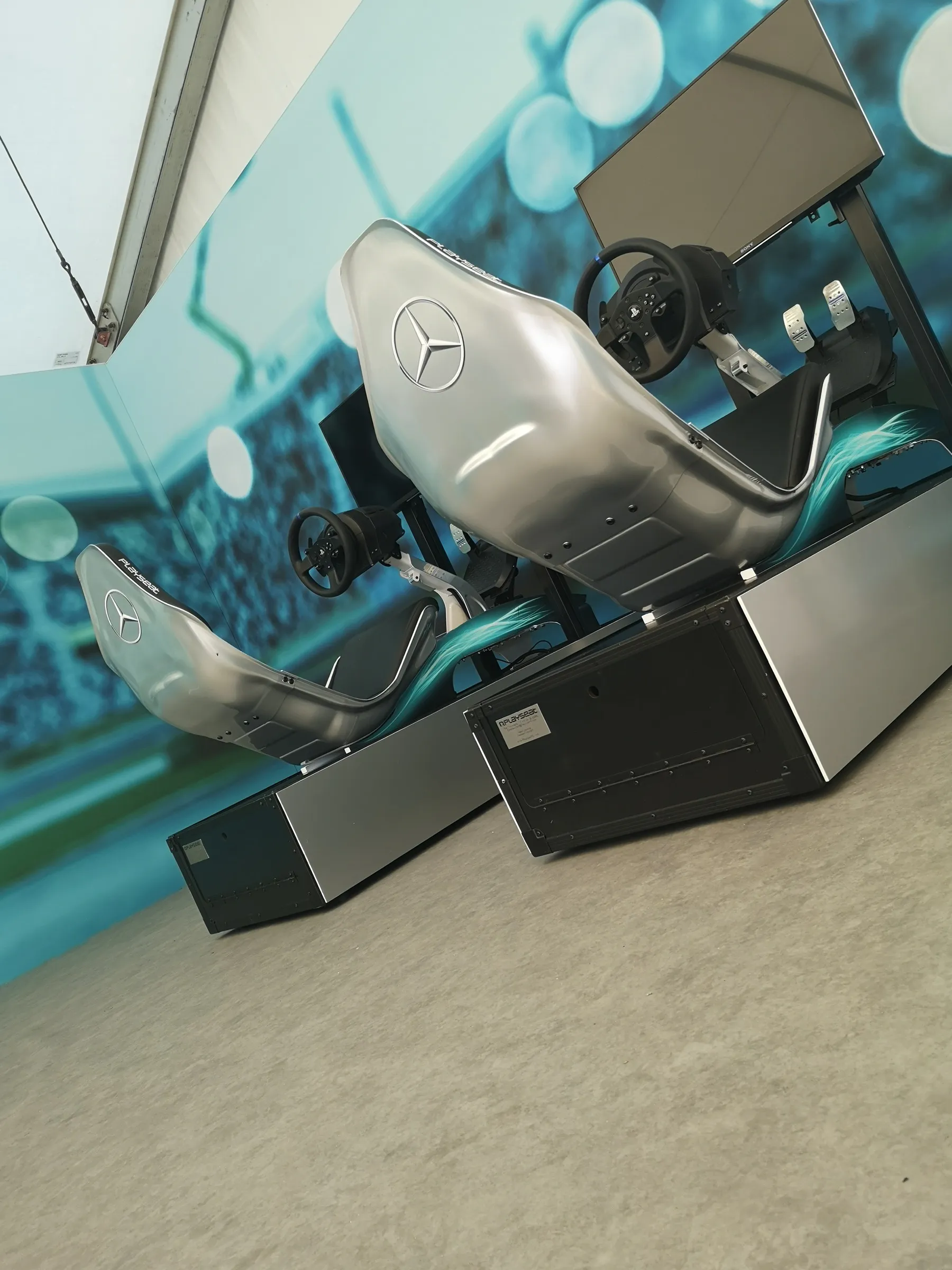 Pair of racing simulators in silver brand wraps