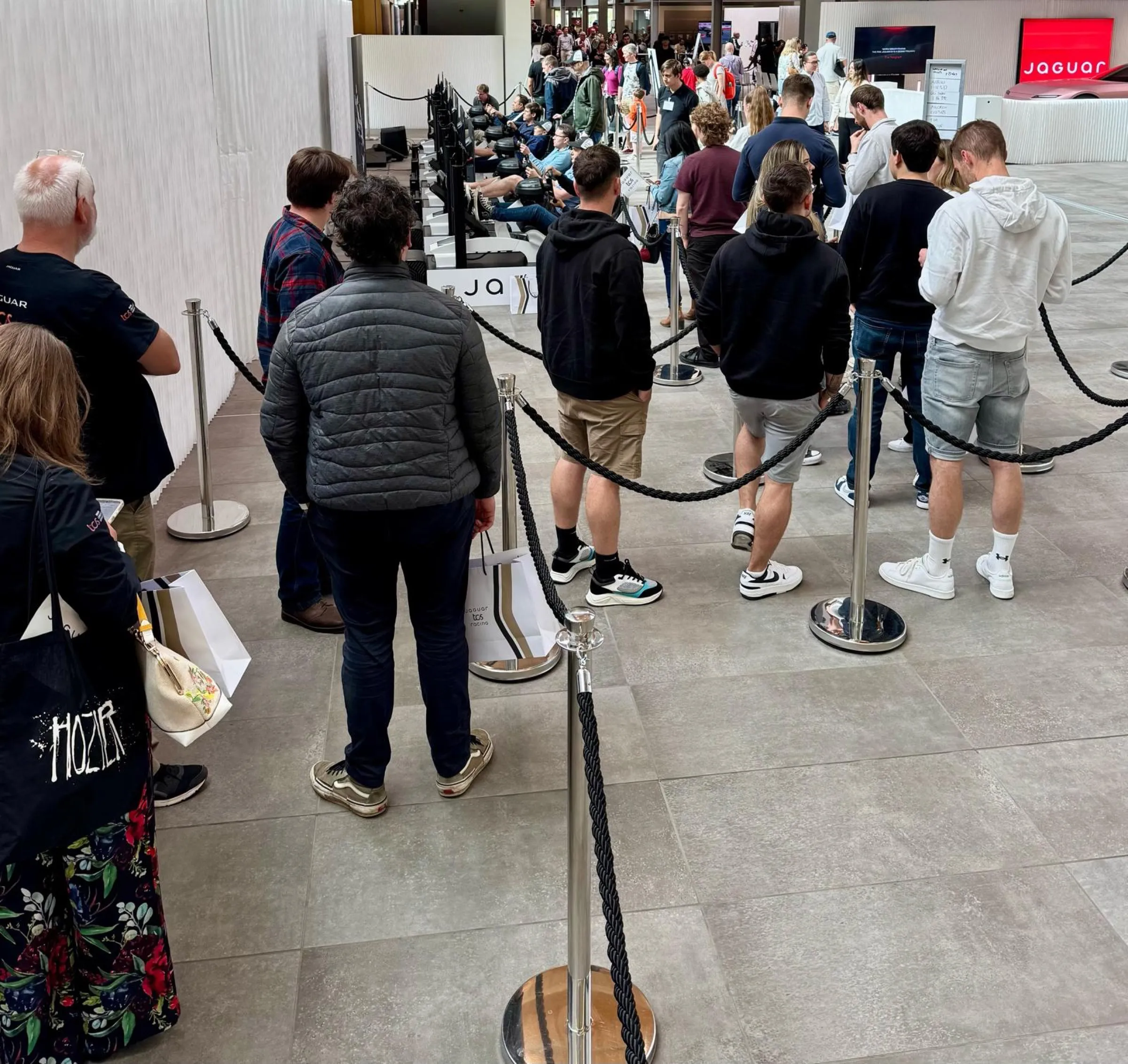 Guests queueing to drive at the Jaguar TCS Racing simulator activation
