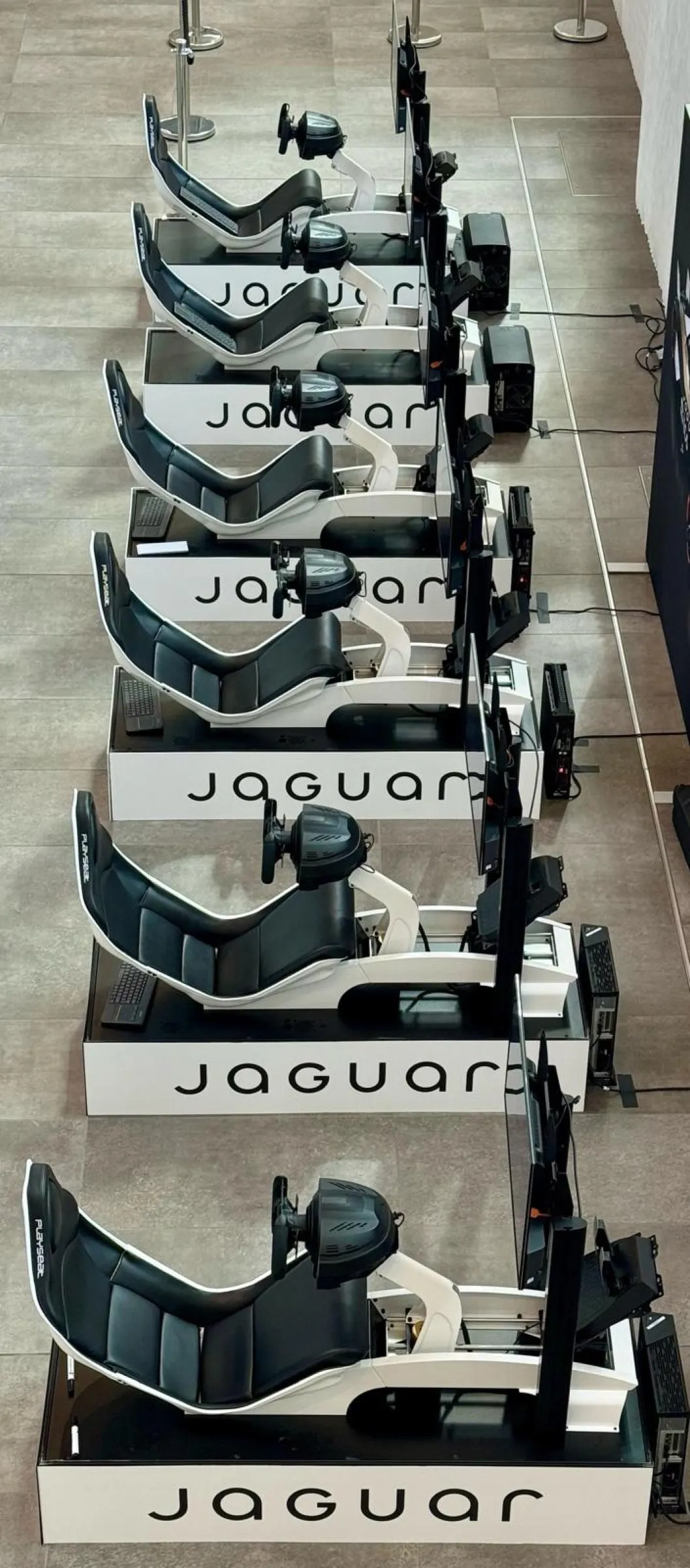 A row of Jaguar branded simulators seen from above