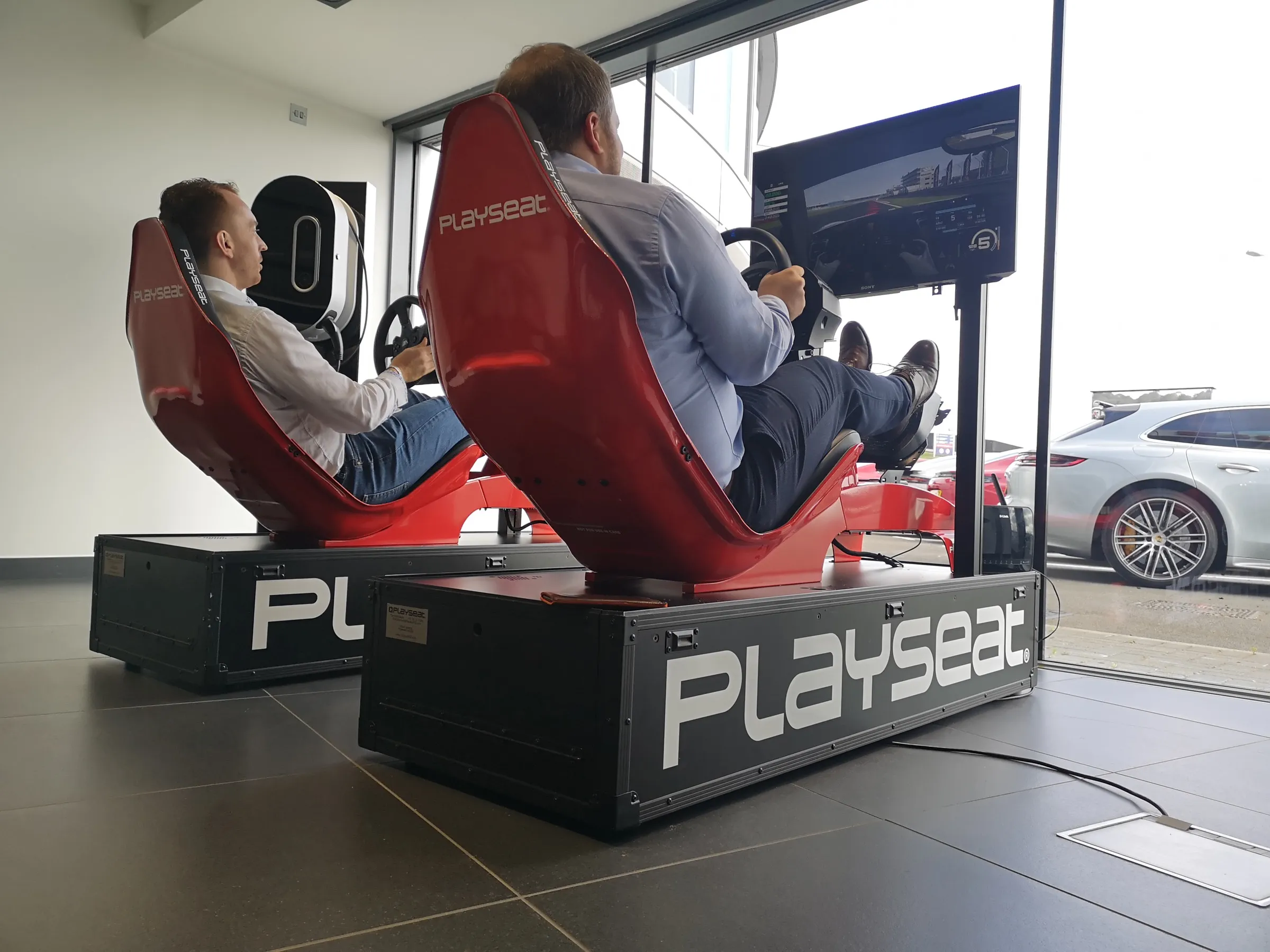 Virtually Entertained crew running simulators with guests racing