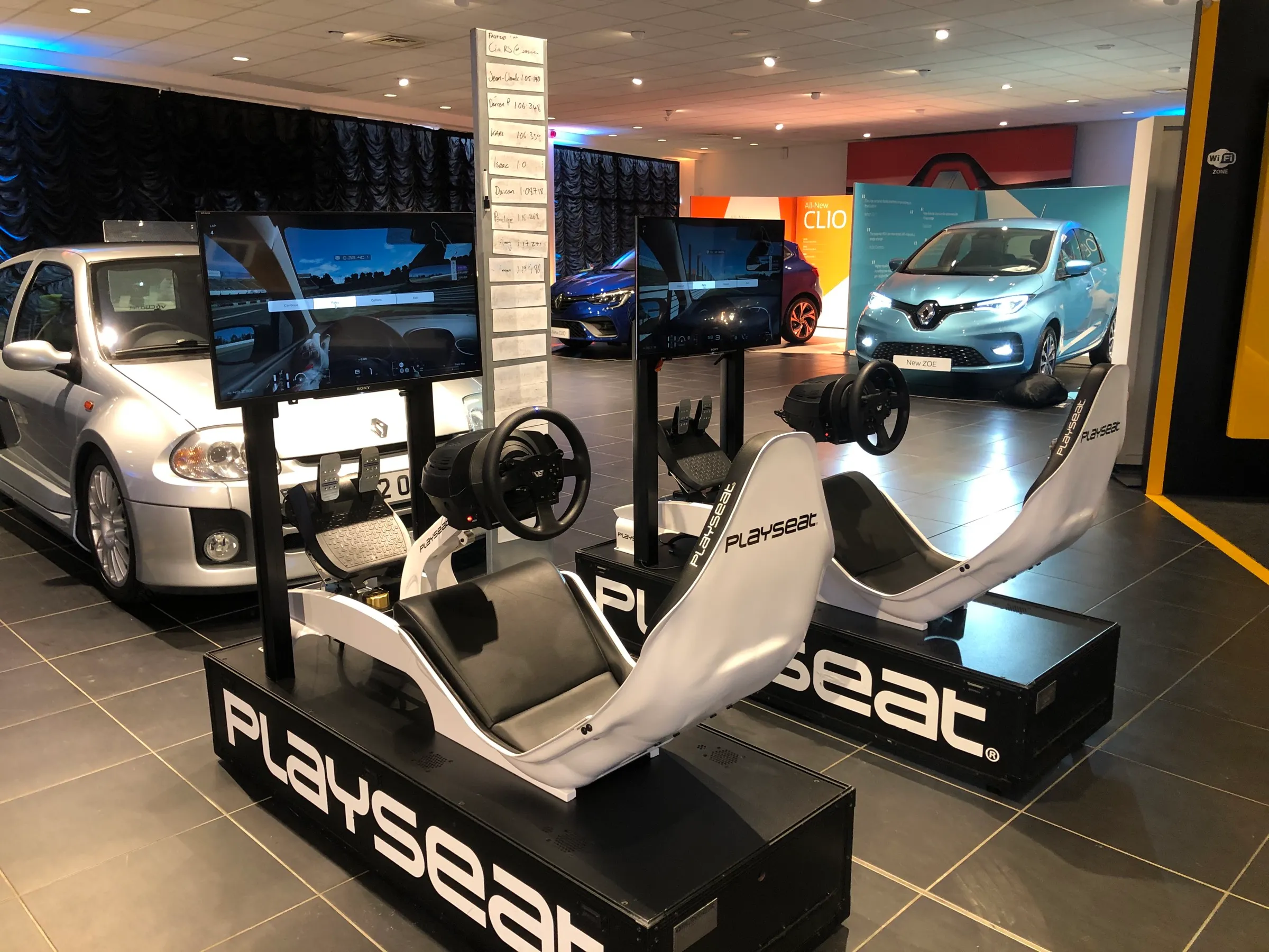 Twin racing simulators with a live leaderboard screen
